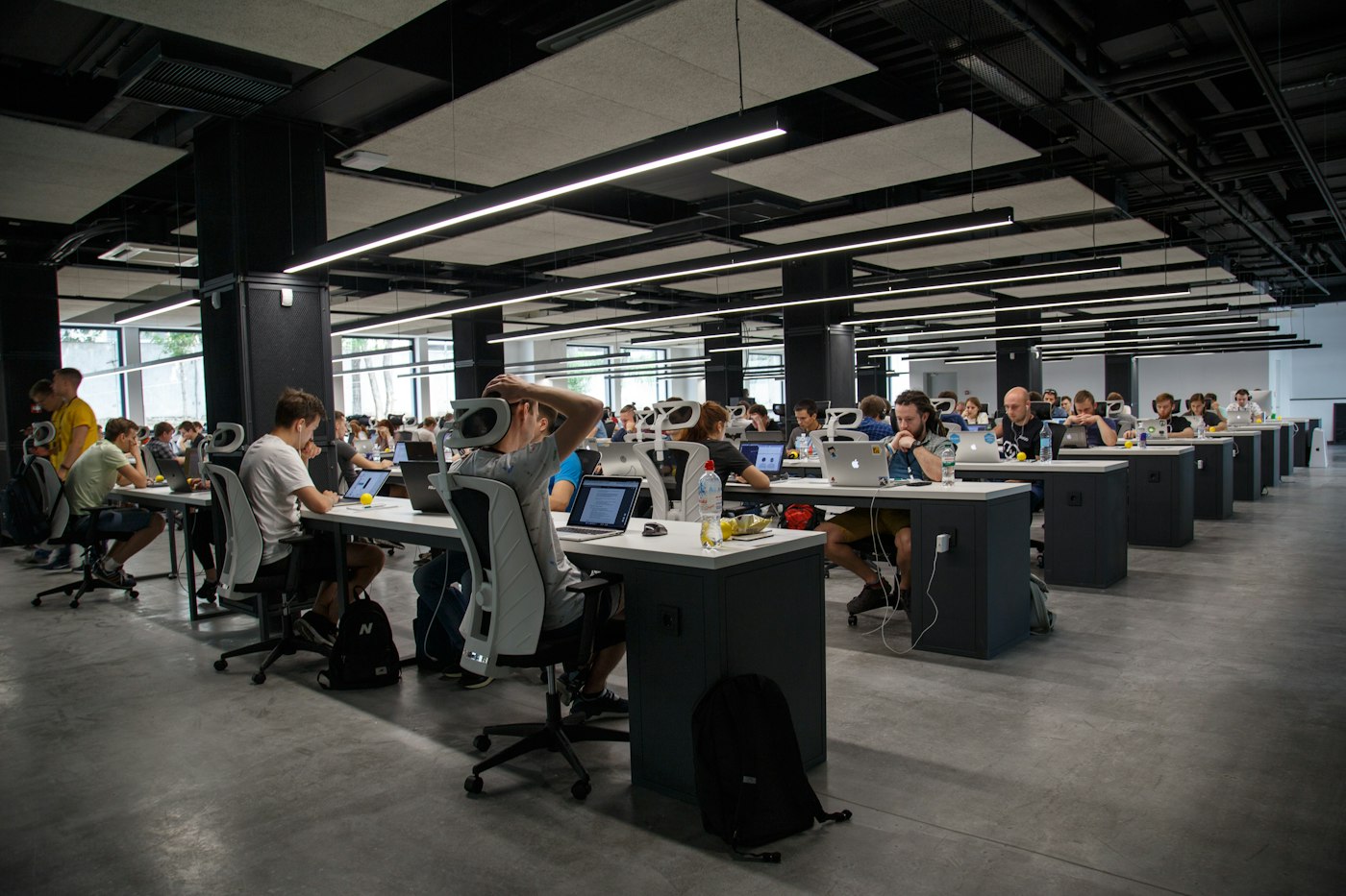Open-plan workspace with teams working at their desks