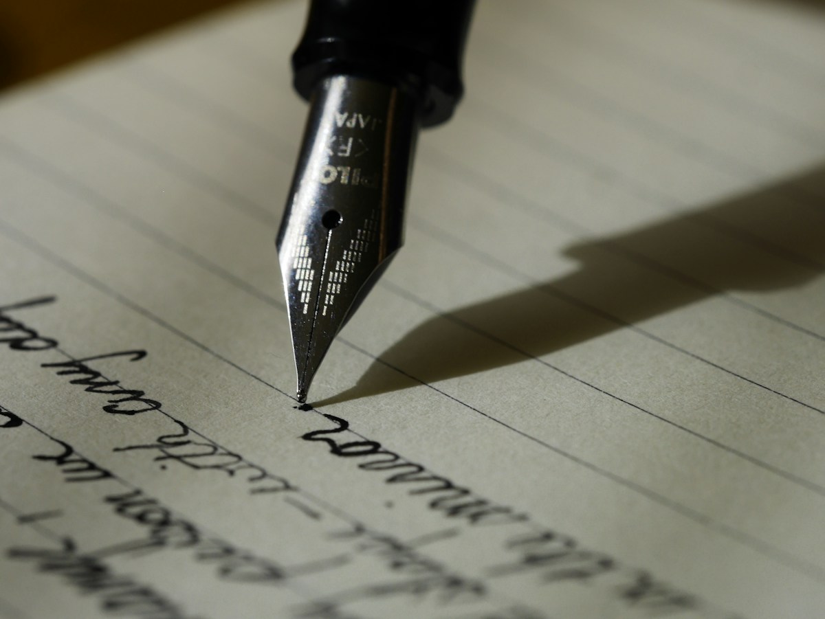 Close-up of a fountain pen making notes on paper